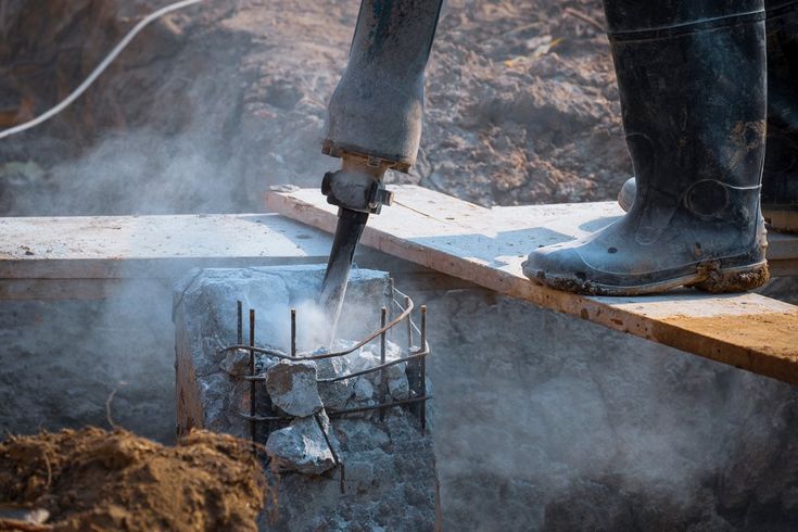 Low,Section,Of,Construction,Worker,Using,Jackhammer,Drill,Equipment,To